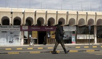 A policeman walks as he secures the Sanaa International Airport, in Yemen, Wednesday, Aug. 7, 2013. The State Department on Tuesday ordered non-essential personnel at the U.S. Embassy in Yemen to leave the country. (AP Photo/Hani Mohammed)