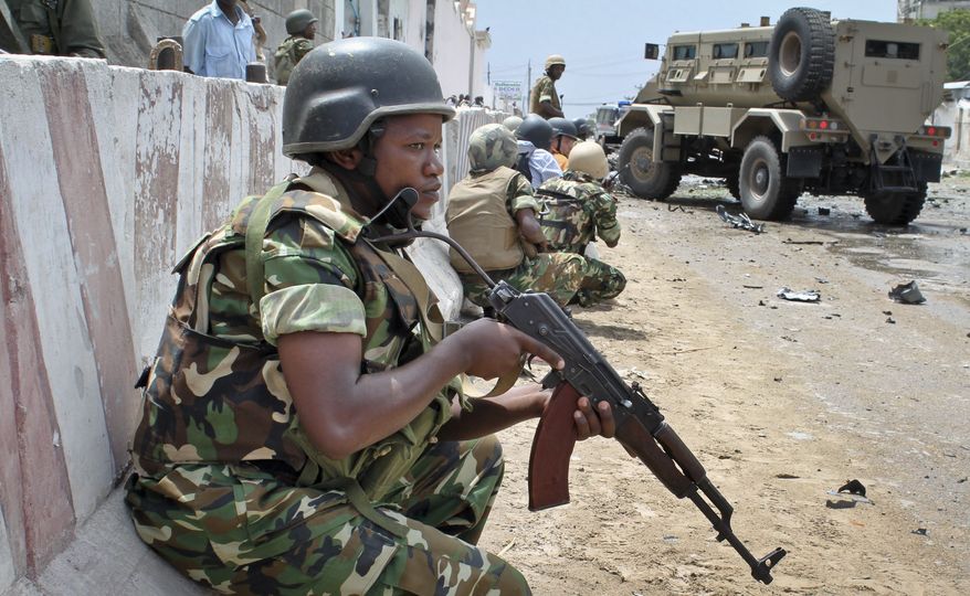 **FILE** African Union peacekeepers take position outside the main U.N. compound, following an attack on it in Mogadishu, Somalia, on June 19, 2013. Al Qaeda-linked militants detonated multiple bomb blasts and engaged in ongoing battles with security forces in an attempt to breach the main U.N. compound in Mogadishu, officials said. (Associated Press)