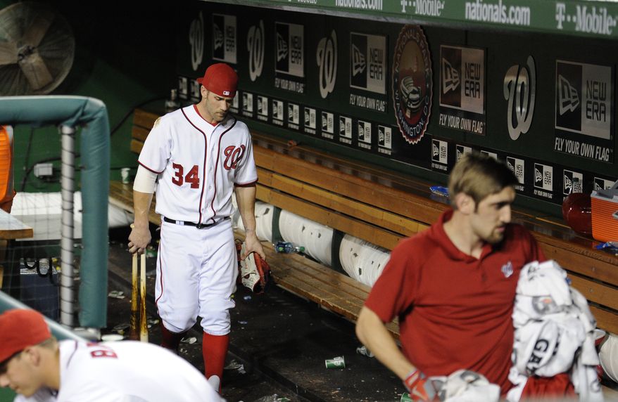 Washington Nationals outfielder Bryce Harper walks through the dugout after his team was swept by the Atlanta Braves Wednesday night. (Associated Press photo)