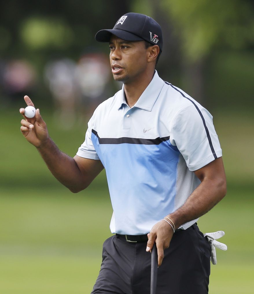 Tiger Woods waves after a par on the 17th hole during the first round of the PGA Championship golf tournament at Oak Hill Country Club, Thursday, Aug. 8, 2013, in Pittsford, N.Y. (AP Photo/Patrick Semansky)