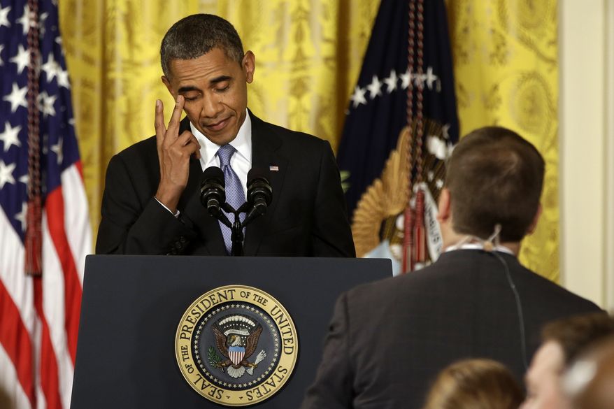 President Obama rubs his eye as he listens to a question from a reporter during a news conference in the East Room of the White House in Washington on Aug. 9, 2013. The president said the U.S. will pause and reassess relations with Russia because of Putin's 'backward' thinking. (Associated Press)