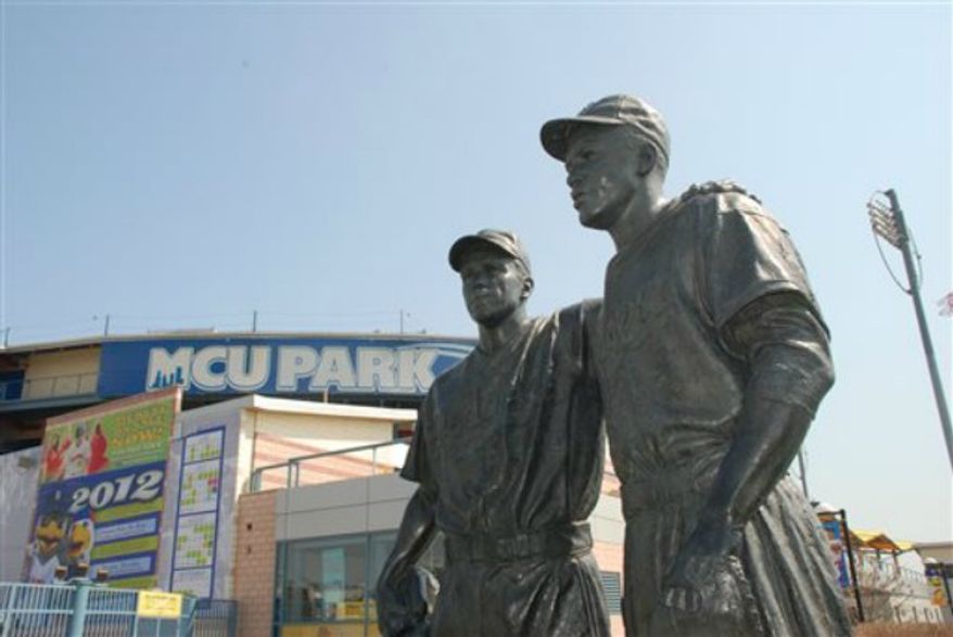 ** FILE ** New York City police are investigating swastikas and hate speech scrawled on a statue of Pee Wee Reese and Jackie Robinson outside Brooklyn's minor league baseball stadium. A manager at MCU Park noticed the defacement Wednesday morning, Aug. 7, 2013. (AP Photo/Brooklyn Cyclones)