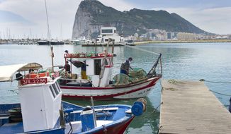 **FILE** Spanish fishing boats sit moored in La Linea de Concepcion, Spain, in front of Gibraltar on May 28, 2012. (Associated Press)