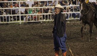 ** FILE ** A clown wears a mask intended to look like President Obama at the Missouri State Fair. The rodeo announcer asked the crowd if anyone wanted to see “Obama run down by a bull,” according to a spectator. “So then everybody screamed. ... They just went wild,” said Perry Beam, who attended the event at the state fair in Sedalia, Mo., on Saturday, Aug. 10, 2013. Fair officials apologized, calling the display inappropriate and disrespectful. (AP Photo/Jameson Hsieh)