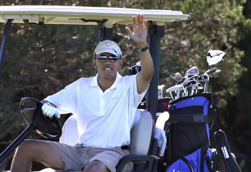 President Obama waves to a group of on-lookers while golfing at Farm Neck Golf Club in Oak Bluffs, Mass., on the island of Martha's Vineyard on Aug. 11, 2013. (Associated Press)