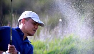 ** FILE ** President Obama swings to hit the ball out of a sand trap while playing golf at the Vineyard Golf Club, in Edgartown, Mass., on the island of Martha&#39;s Vineyard, Friday, Aug. 19, 2011. (AP Photo/Steven Senne)