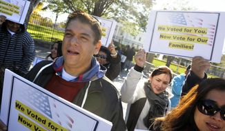 **FILE** Members of immigration rights organizations, including Casa in Action and Maryland Dream Act, demonstrate Nov. 8, 2012, in front of the White House as they call on President Obama to fulfill his promise of passing comprehensive immigration reform. (Associated Press)