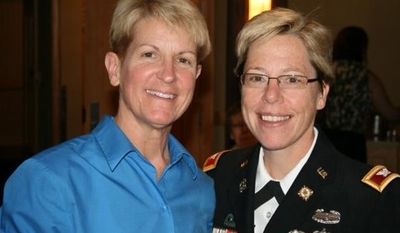 Army Brig. Gen. Tammy Smith (right) became the military's first openly gay flag officer when she was promoted to her current rank in an Aug. 10, 2012, ceremony. She received her new decorations from her wife, Tracey Hepner (left). (Servicemembers Defense Legal Network)