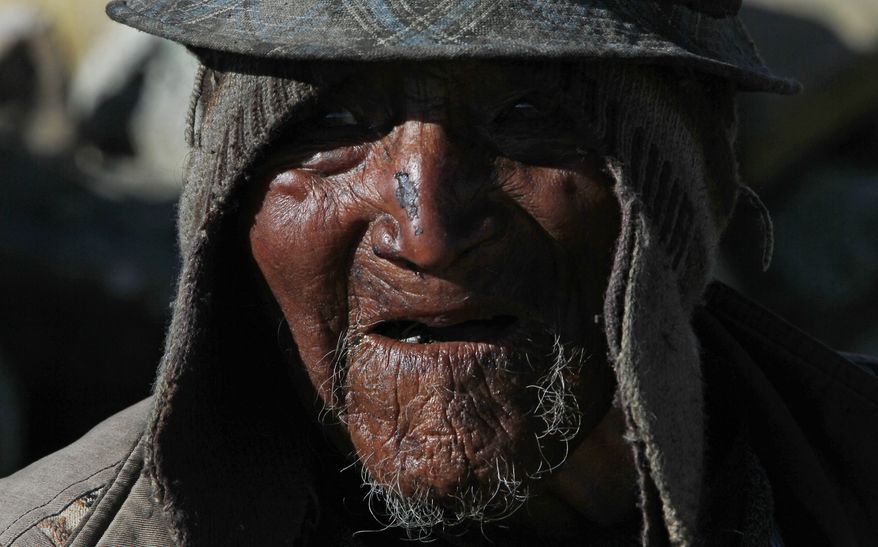 Carmelo Flores Laura, a native Aymara, speaks during an interview outside his home in the village of Frasquia, Bolivia, Tuesday, Aug. 13, 2013. If Bolivia’s public records are correct, Flores is the oldest living person ever documented. They say he turned 123 a month ago. To what does the cattle and sheepherder owe his longevity? “I walk a lot, that’s all. I go out with the animals,” he said. (AP Photo/Juan Karita)