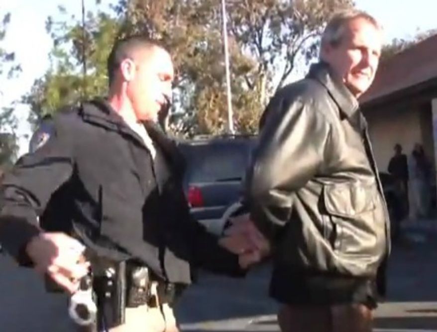 Mark Mackey is arrested outside a California DMV in 2011 for reading a bible out loud to "a captive audience." All charges have been dropped against him. (Image: YouTube)