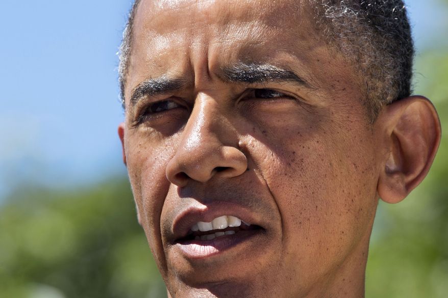 **FILE** President Obama makes a statement to the media from his rental vacation home in Chilmark Mass., on the island of Martha's Vineyard on Aug. 15, 2013. (Associated Press)
