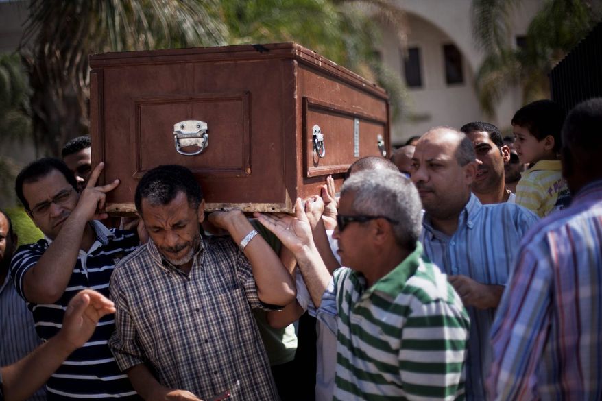 Friends and relatives of Ammar Badie, 38 and son of Muslim Brotherhood's spiritual leader Mohammed Badie, killed Friday by Egyptian security forces during clashes in Ramses Square, carry his coffin during his funeral in al-Hamed mosque in Cairo on Sunday. Egypt increased security at the Supreme Constitutional Court building ahead of planned mass rallies by supporters of ousted President Mohammed Morsi. (Associated Press)