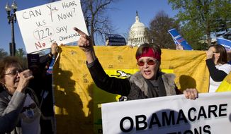 **FILE** Linda Door of Laguna Beach, Calif., protests outside the United States Supreme Court in Washington on March 26, 2012, as the court begins hearing arguments on the constitutionality of President Obama&#39;s health care overhaul, the Patient Protection and Affordable Care Act. (Associated Press)