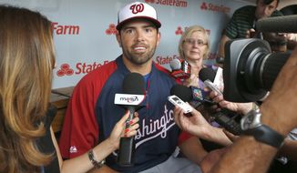 Washington Nationals&#39; David DeJesus, center, talks with reporters after he was traded by the Chicago Cubs to the National before a baseball game between the Cubs and Nationals at Wrigley Field, Monday, Aug. 19, 2013, in Chicago. (AP Photo/Charles Rex Arbogast)