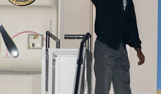 President Obama waves from the door of Air Force One at the Cape Cod Coast Guard Station in Bourne, Mass.,  on Sunday, Aug. 18, 2013, after ending his vacation on Martha&#39;s Vineyard. (AP Photo/Stew Milne)