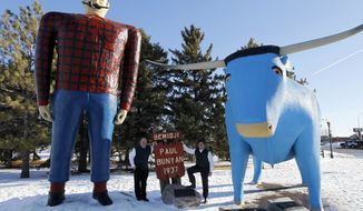 **FILE** Republican presidential candidate and former Pennsylvania Sen. Rick Santorum (right) stands below the Paul Bunyan and Babe the Blue Ox statues with Bill Batchhelder during a campaign stop in Bemidji, Minn., on Feb. 5, 2012. Bachhelder&#39;s company, Bemidji Woolen Mills, manufactures the official &quot;Santorum for President&quot; sweater vest. (Associated Press)