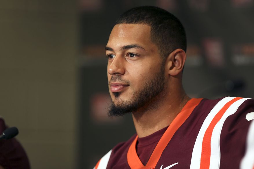 Virginia Tech quarterback Logan Thomas attends NCAA college football media day in Lane Stadium on campus in Blacksburg, Va., Saturday, Aug.10 2013. (AP Photo/The Roanoke Times, Matt Gentry)