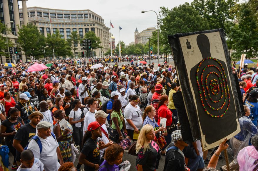 People participate in a march down Pennsylvania Avenue to commemorate the 50th anniversary of the March on Washington and Martin Luther King Jr.&#x27;s famous &quot;I Have a Dream&quot; speech in D.C. on Aug. 28, 2013. (Andrew Harnik/The Washington Times)