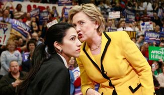 Hillary Rodham Clinton (right) shares a word with Huma Abedin, her personal assistant and trusted confidant. **FILE**