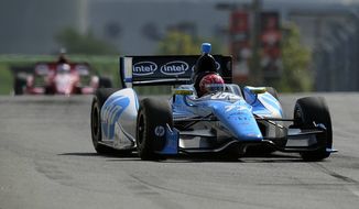 Simon Pagenaud, of France, drives during a warm up session for the IndyCar Grand Prix of Baltimore auto race, Sunday, Sept. 1, 2013, in Baltimore. (AP Photo/Nick Wass)