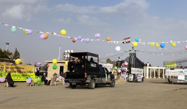 ** FILE ** Iraqi security forces enter through the main gate of Camp Ashraf in Khalis, northeast of Baghdad, Iraq, on Friday, Feb. 17, 2012. (AP Photo/Hadi Mizban)