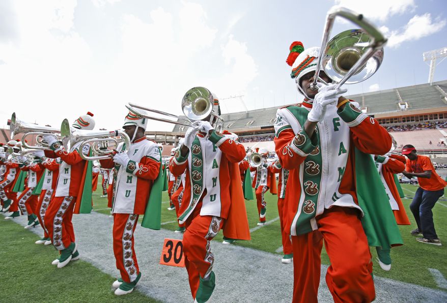 The Florida A&M University band performs Sunday, Sept. 1, 2013, in Orlando, Fla. With trials still pending for several defendants in the hazing death of a former drum major, the band makes its return performance after a 22-month absence during FAMU’s season-opening football game against Mississippi Valley State. (AP Photo/John Raoux)
