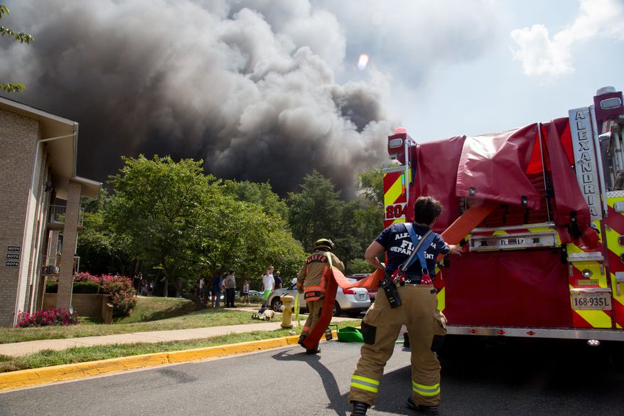 Smoke billows into the sky as fire fighters try to put it out, in Alexandria, VA., Monday , September 2, 2013. (Andrew S Geraci/The Washington Times)