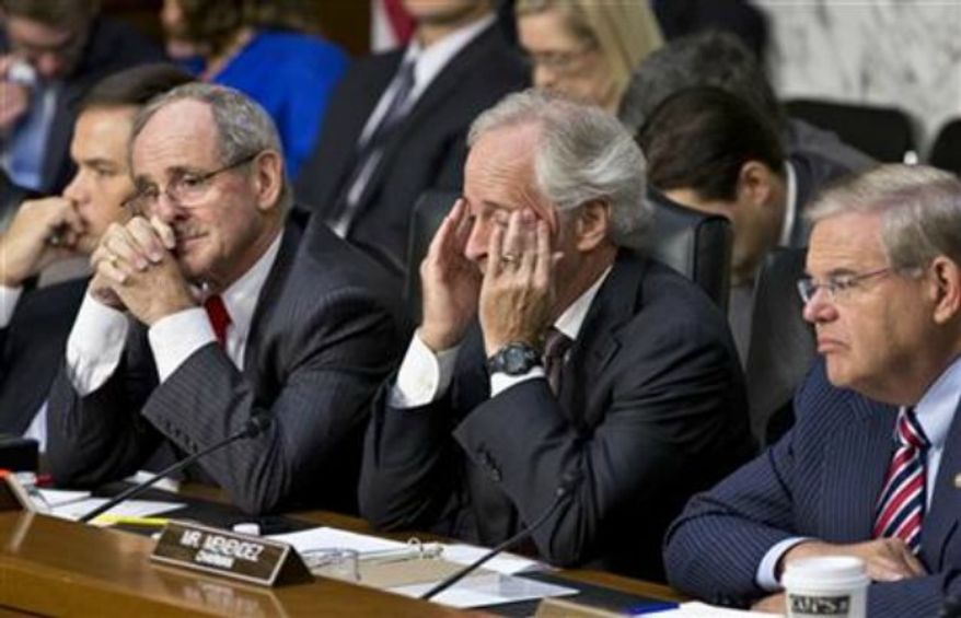 From right to left, Senate Foreign Relations Chairman Robert Menendez, D-N.J., Sen. Bob Corker, R-Tenn., the ranking member, Sen. James Risch, R-Idaho, and Sen. Marco Rubio, R-Fla., listen to testimony from Secretary of State John Kerry, and Defense Secretary Chuck Hagel at a hearing on President Obama's request for congressional authorization for military intervention in Syria, a response to last month's alleged sarin gas attack in the Syrian civil war, on Capitol Hill in Washington, Tuesday, Sept. 3, 2013. (AP Photo/J. Scott Applewhite)