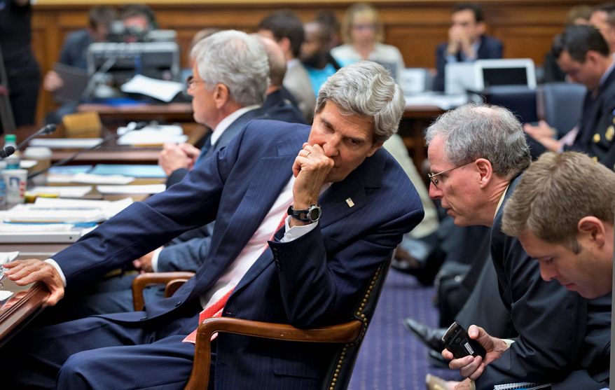 Secretary of State John F. Kerry confers with U.S. Ambassador to Syria Robert Ford on Capitol Hill on Wednesday during a House Foreign Affairs Committee hearing on President Obama's request for congressional authorization for military intervention in Syria. The assault would be a response to a chemical weapons attack in the Syrian civil war. (Associated Press)