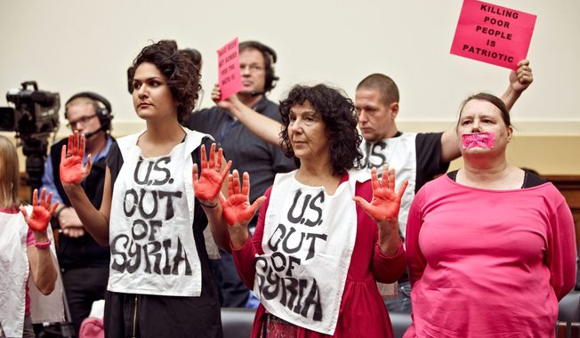 Code Pink protesters bring their anti-war message to the Capitol before Wednesday&#x27;s House hearing on President Obama&#x27;s request for military intervention in Syria. (Associated Press)