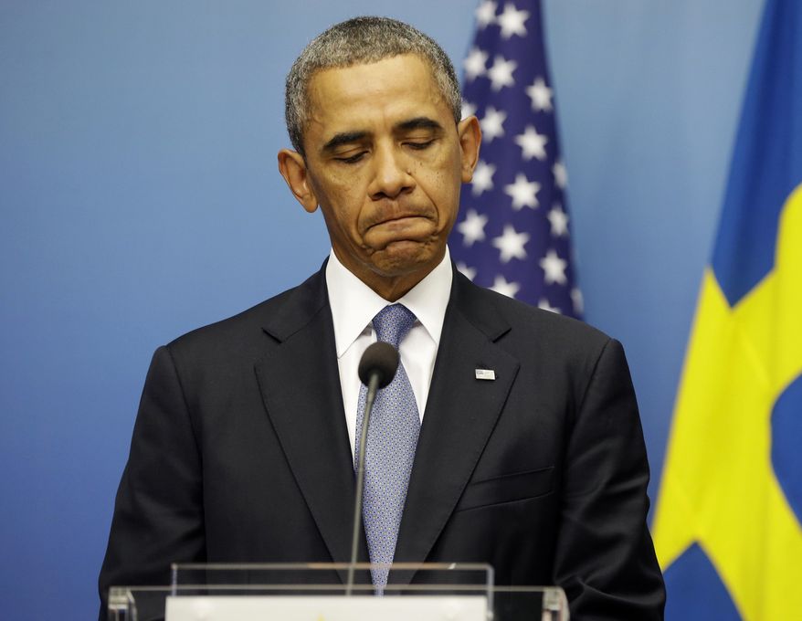 President Barack Obama pauses during his joint news conference with Swedish Prime Minister Fredrik Reinfeldt, Wednesday, Sept. 4, 2013, at the Rosenbad Building in Stockholm, Sweden. The president said international community and Congress credibility on the line on response to Syria. (AP Photo/Pablo Martinez Monsivais)
