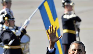 U.S. President Barack Obama waves upon arrival at Arlanda Airport, in Stockholm, Sweden, Wednesday, Sept. 4, 2013, with the Swedish flag and guard of honor in the background. President Barack Obama is opening a three-day overseas trip with a stop in the Swedish capital of Stockholm. Air Force One touched down Wednesday morning after an overnight flight from Washington. During his stay in Stockholm, Obama will meet with Swedish Prime Minister Fredrik Reinfeldt and King Carl XVI Gustaf. He will also meet with other Nordic leaders from Finland, Denmark, Iceland and Norway. (AP Photo/Scanpix Sweden, Anders Wiklund) 
