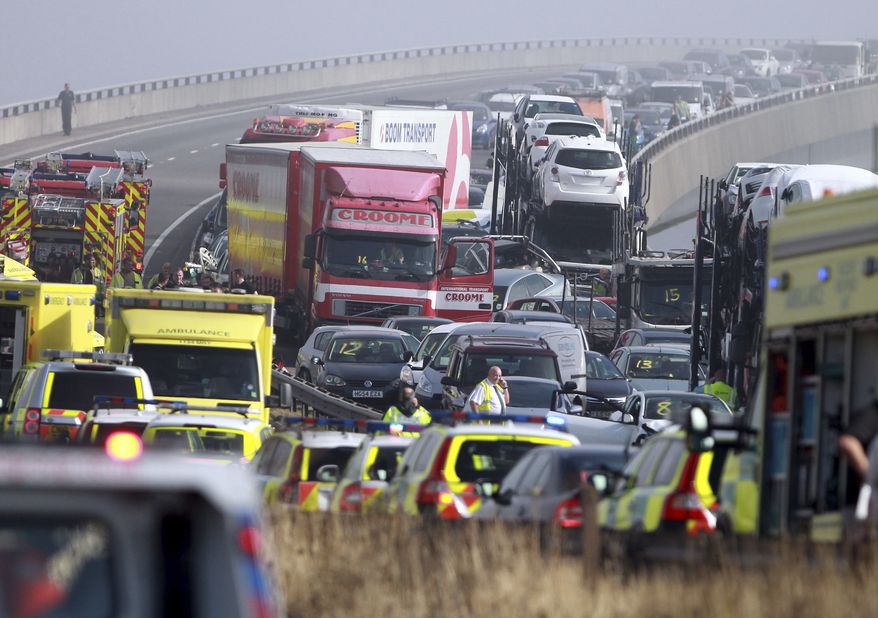 Emergency vehicles attend the scene of a major accident on the Sheppey Bridge Crossing near Sheerness in Kent, south England, following a multi-vehicle collision earlier Thursday morning, Sept. 5, 2013. (AP Photo/Gareth Fuller, PA)