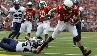 Maryland quarterback C.J. Brown (16) runs into the end zone past Old Dominion safety Fellonte Misher (24) for a touchdown in the first half of an NCAA college football game in College Park, Md., Saturday, Sept. 7, 2013. (AP Photo/Patrick Semansky)