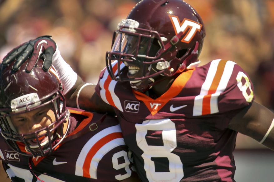 Virginia Tech’s Detrick Bonner (8) and James Gayle (99) celebrate a touchdown after a first quarter interception during their NCAA college football game in Blacksburg, Va., Saturday, Sept. 7, 2013. Virginia Tech defeated Western Carolina 44-3. (AP Photo/The Roanoke Times, Matt Gentry)