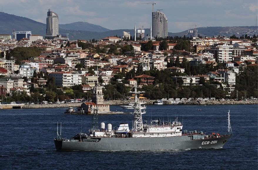 Moscow on a mission: A Russian military intelligence ship leads a naval fleet through the Bosporus on Thursday en route to the eastern Mediterranean for observation of U.S. ships and to serve as a roadblock to international action against Syria. (Associated Press)