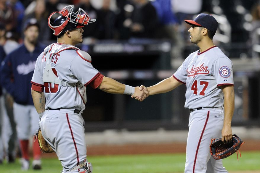 Washington Nationals left-hander Gio Gonzalez, left, gets a handshake from catcher Wilson Ramos after his one-hit shutout over the New York Mets in the Nationals' 9-0 victory. Gonzalez was inches from a no-hitter. (Associated Press photo)