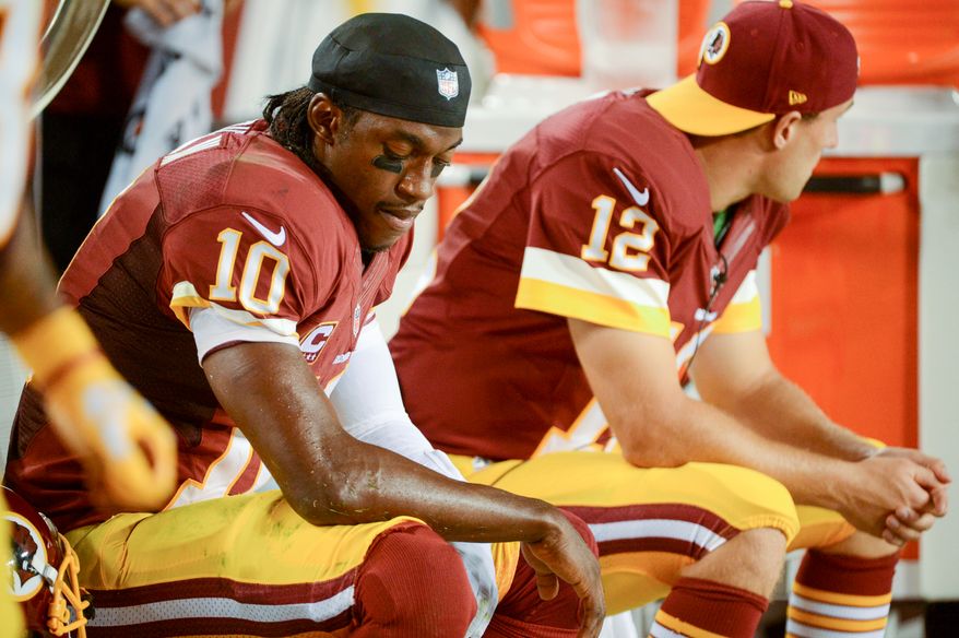 Washington Redskins quarterback Robert Griffin III (10) sits on the sideline in the third quarter as the Washington Redskins play the Philadelphia Eagles in Monday Night NFL football at FedExField, Landover, Md., Monday, September 9, 2013. (Andrew Harnik/The Washington Times)