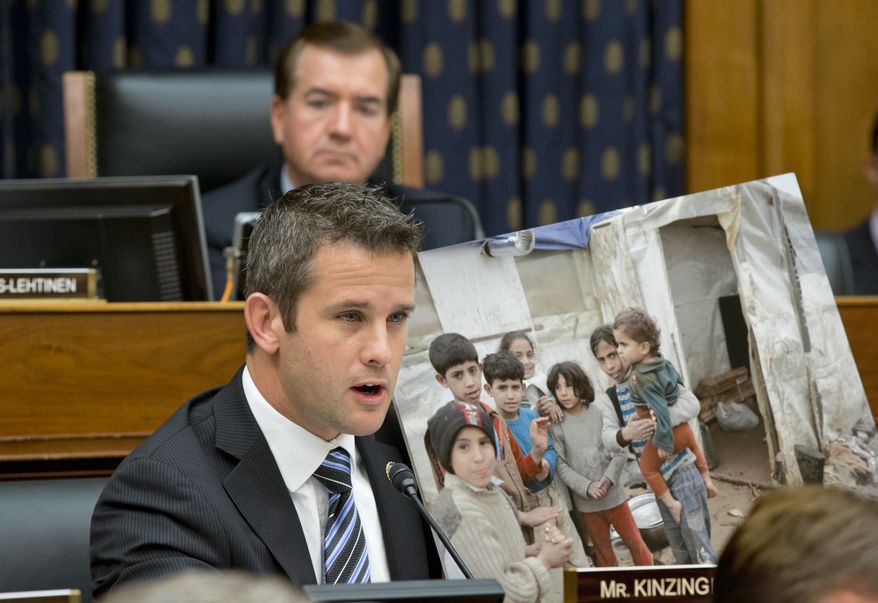 Rep. Adam Kinzinger (foreground), Illinois Republican, displays a photo of Syrian children while questioning Secretary of State John F. Kerry at a House Foreign Affairs Committee hearing on President Obama&#39;s request for congressional authorization for military intervention in Syria, a response to last month&#39;s alleged sarin gas attack in the Syrian civil war, on Capitol Hill in Washington on Wednesday, Sept. 4, 2013. Rep. Edward R. Royce, California Republican, who is the panel&#39;s chairman, listens at top. (AP Photo/J. Scott Applewhite)