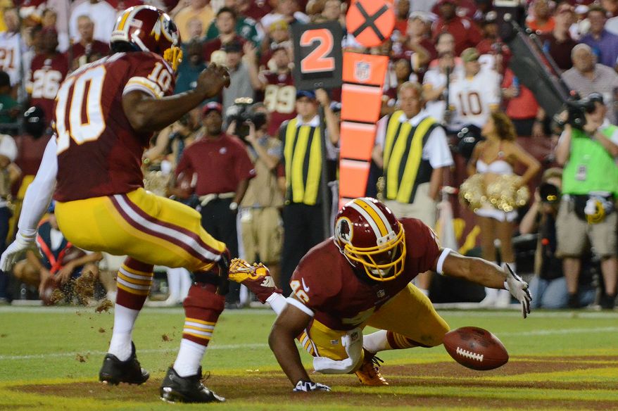 Washington Redskins running back Alfred Morris (46) recovers a fumble by Washington Redskins quarterback Robert Griffin III (10) in the endzone for a safety in the first quarter as the Washington Redskins play the Philadelphia Eagles in Monday Night NFL football at FedExField, Landover, Md., Monday, September 9, 2013. (Dan Decook / For The Washington Times)