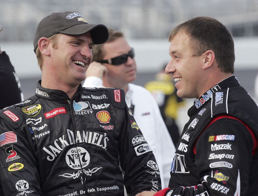 FILE - In this Sept. 14, 2007 file photo, Clint Bowyer, left, smiles with NASCAR driver Ryan Newman after Bowyer won the pole position for the Sylvania 300 NASCAR auto race at New Hampshire International Speedway in Loudon, N.H. His reputation has been battered, his team blasted by NASCAR for manipulating the outcome of a pivotal race. Now Clint Bowyer will do his best to pick up the pieces and try to salvage his season.   (AP Photo/Jim Cole, File)