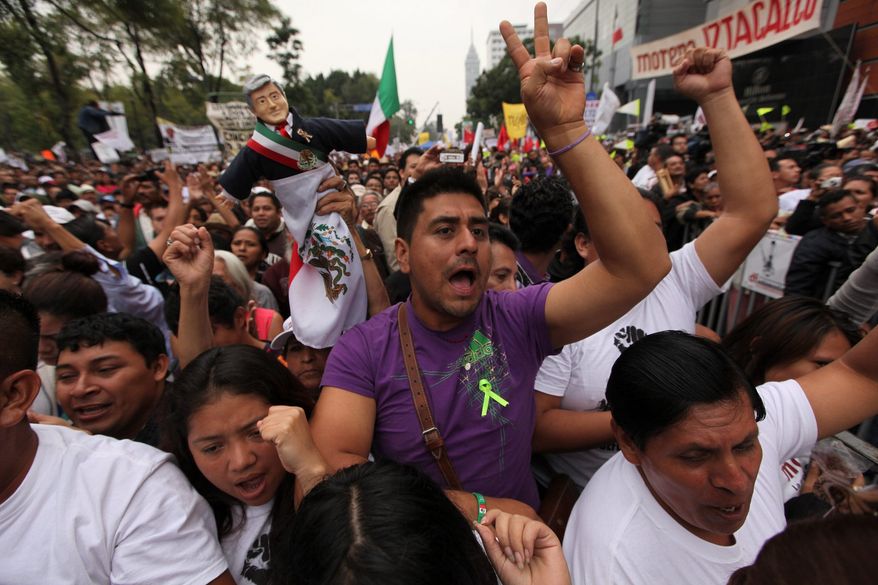 Supporters of former presidential candidate Andres Manuel Lopez Obrador cheer during a protest against the proposed energy reforms that would allow private companies to explore the country&#39;s oil and gas reserves. The proposal requires constitutional changes that strike at the heart of one of Mexico&#39;s proudest moments: President Lazaro Cardenas&#39; nationalization of the oil company in 1938.