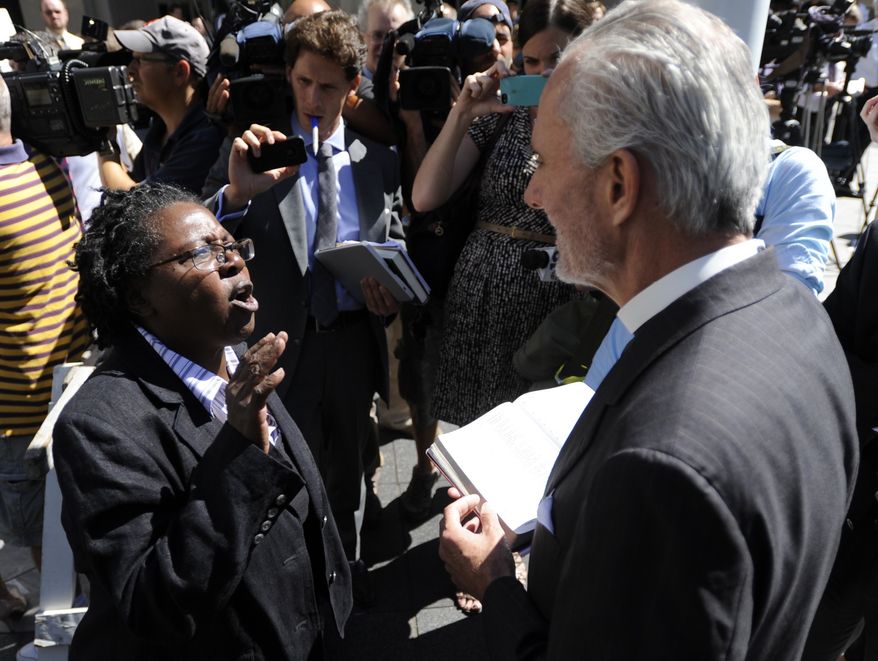 ** FILE ** Stephanie Denise-Carter, left, a supporter of gay marriages, argues with Pastor Bill Devlin, right, outside the Pennsylvania Judicial Center following the hearing of Montgomery County Clerk Bruce Hanes issuing same-sex marriage licenses Wednesday, Sept. 4, 2013, in Harrisburg, Pa. (AP Photo/Bradley C Bower)