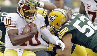 Washington Redskins quarterback Robert Griffin III (10) is sacked by Green Bay Packers outside linebacker Clay Matthews during the first half of an NFL football game Sunday, Sept. 15, 2013, in Green Bay, Wis. (AP Photo/Tom Lynn) 