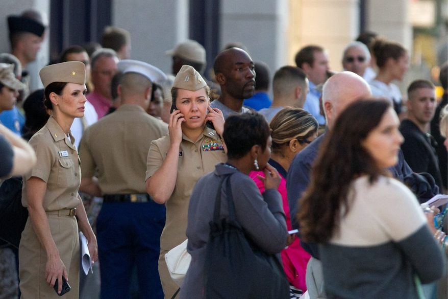 Family and friends wait to greet staff of the Naval Sea Systems Command headquarters as they are bused from the Washington Navy Yard to Nationals Park, in Washington, Monday, Sept. 16, 2013. At least one gunman launched an attack inside the Washington Navy Yard, spraying gunfire on office workers in the cafeteria and in the hallways at the heavily secured military installation in the heart of the nation's capital, authorities said. (AP Photo/Jacquelyn Martin)