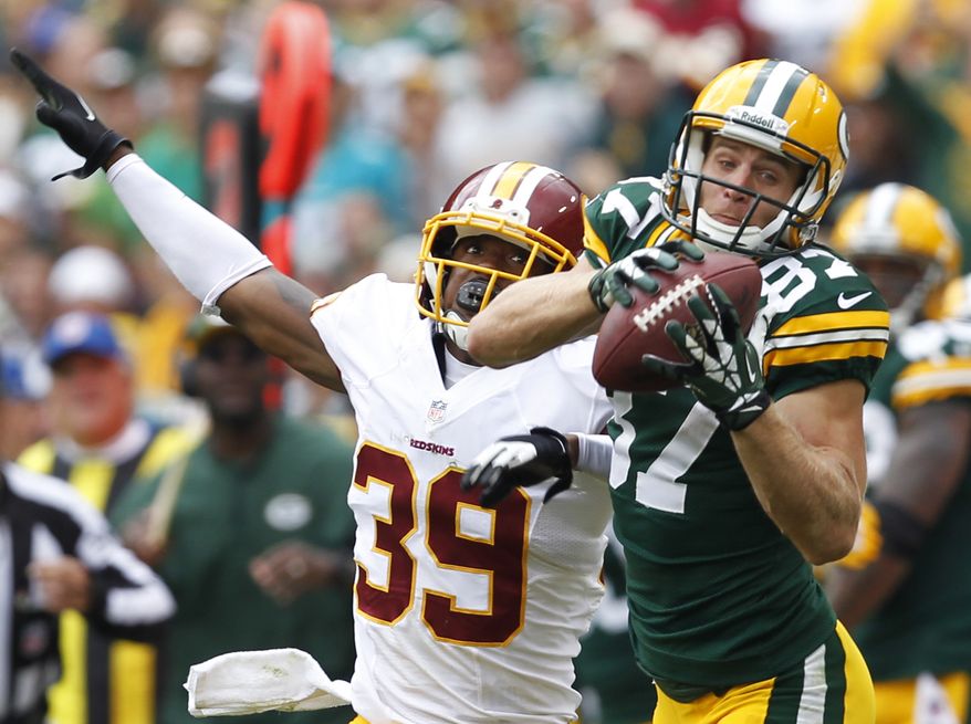 Green Bay Packers' Jordy Nelson (87) catches a pass in front of Washington Redskins' David Amerson (39) during the second half of an NFL football game Sunday, Sept. 15, 2013, in Green Bay, Wis. (AP Photo/Mike Roemer)