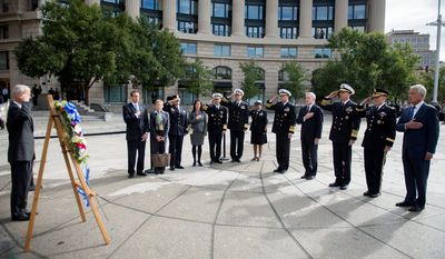 Secretary of Defense Chuck Hagel (right) along with Gen. Martin E. Dempsey, chairman of the Joint Chiefs of Staff; Adm. Jonathan Greenert, chief of Naval Operations; Ray Mabus, Secretary of the Navy; and Adm. James A. Winnefeld Jr., vice chairman of the Joint Chiefs of Staff, render honors Tuesday during a wreath-laying ceremony at the U.S. Navy Memorial. (U.S. Navy via Associated Press)