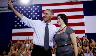 **FILE** President Obama, accompanied by Sandra Fluke, waves at a campaign event at the University of Colorado Auraria Events Center in Aurora, Colo., on Aug. 8, 2012. Fluke is a Georgetown law student who inadvertently gained notoriety when talk show host Rush Limbaugh spoke disparagingly of her testimony before Congress on the issue of contraception and insurance coverage. (Associated Press)