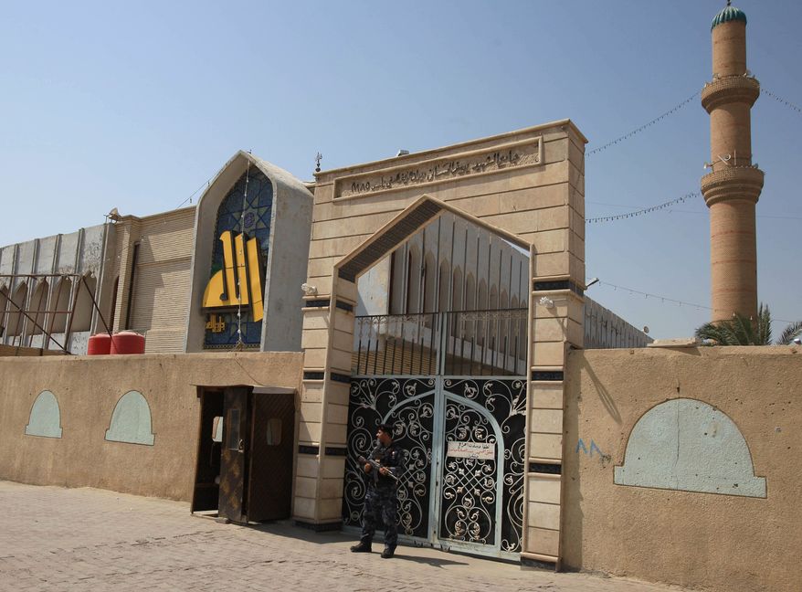 An Iraqi policeman stands guard outside the Sunni Al-Hassan Mosque in Basra, 340 miles (550 kilometers) southeast of Baghdad, Iraq, Tuesday, Sept. 17, 2013. Gunmen have shot dead over a dozen Sunnis in Iraq's Shiite-majority city of Basra over the past two weeks, following threats to retaliate against them for attacks on Shiites in other parts of Iraq, police and a Sunni community leader said. (AP Photo/ Nabil al-Jurani)