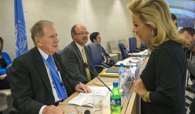 Michael Kirby (left), chairman of the Commission of Inquiry on Human Rights in North Korea, speaks with Ambassador Eileen Chamberlain Donahoe, U.S. representative to the Human Rights Council, before he delivers his report to the 24th session of the council at the European headquarters of the United Nations in Geneva on Tuesday, Sept. 17, 2013. (AP Photo/Keystone, Salvatore Di Nolfi)